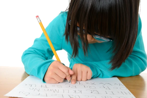 child writing the letters of the alphabet - letter formation